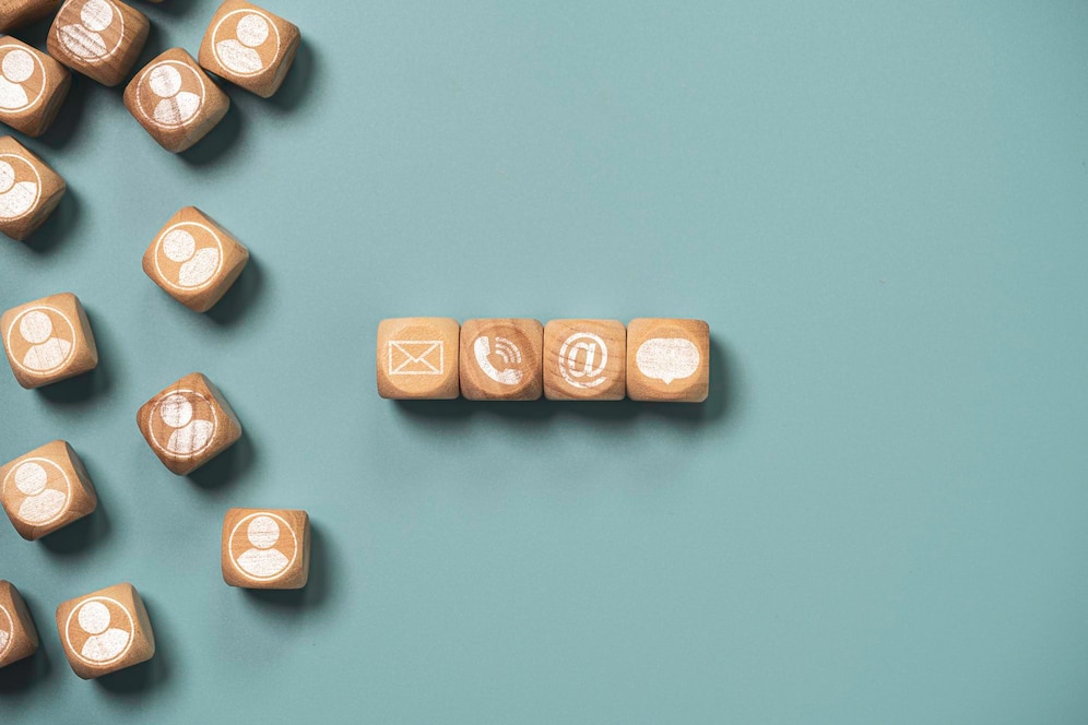 customer-service-business-contact-concept-wooden-cube-block-which-print-screen-letter-telephone-email-address-message_616485-45